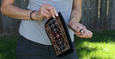 Velvet clutch with brown, yellow, and white Karakalpak embroidery